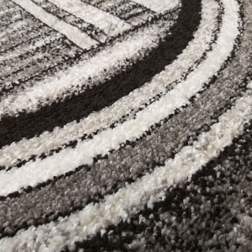 Модерен сиво-кафяв килим с абстрактни кръгове