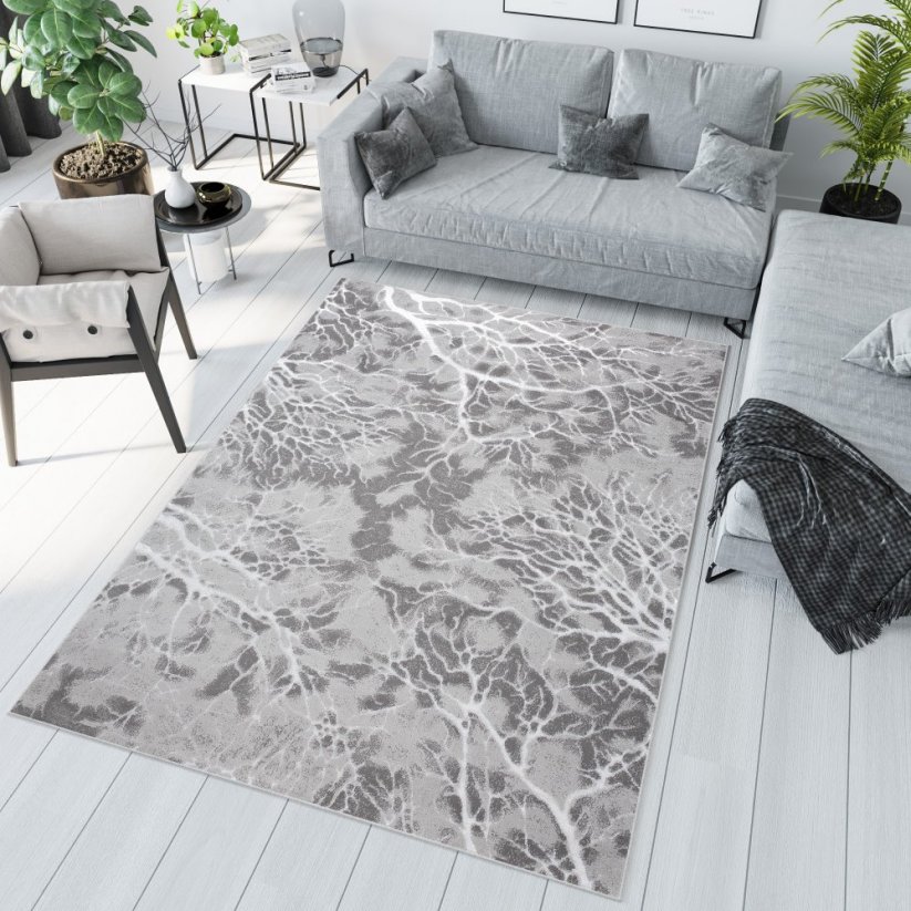 Jednoduchý moderný koberec sivej farby s bielym motívom