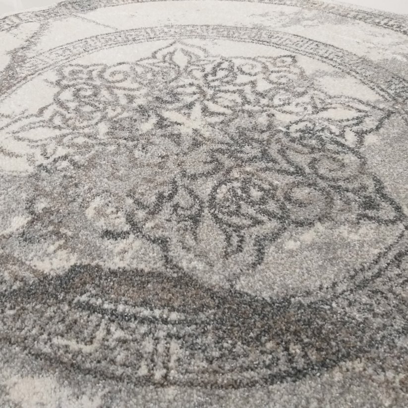 Runder grauer Teppich mit Mandala