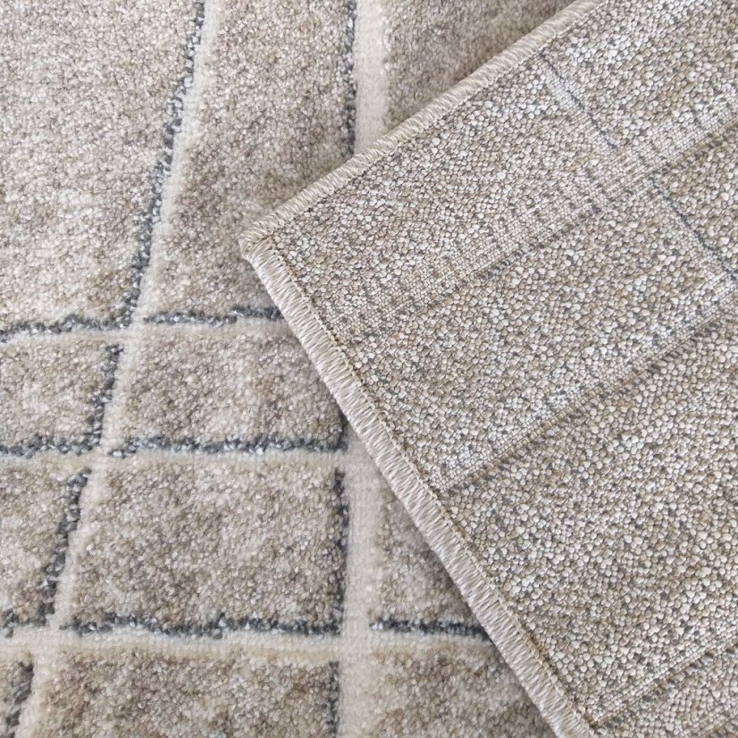 Beigefarbener Teppich mit minimalistischen Mustern 