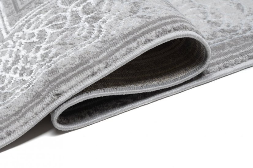 Esclusivo tappeto grigio con motivo orientale bianco