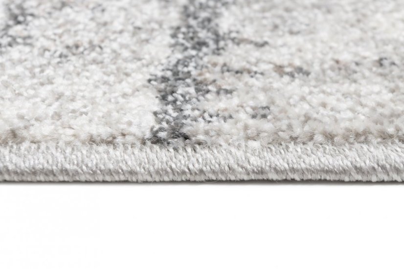Beige-grauer Designteppich mit abstraktem Muster 