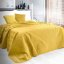 Obojstranný prešívaný prehoz na posteľ žltej farby