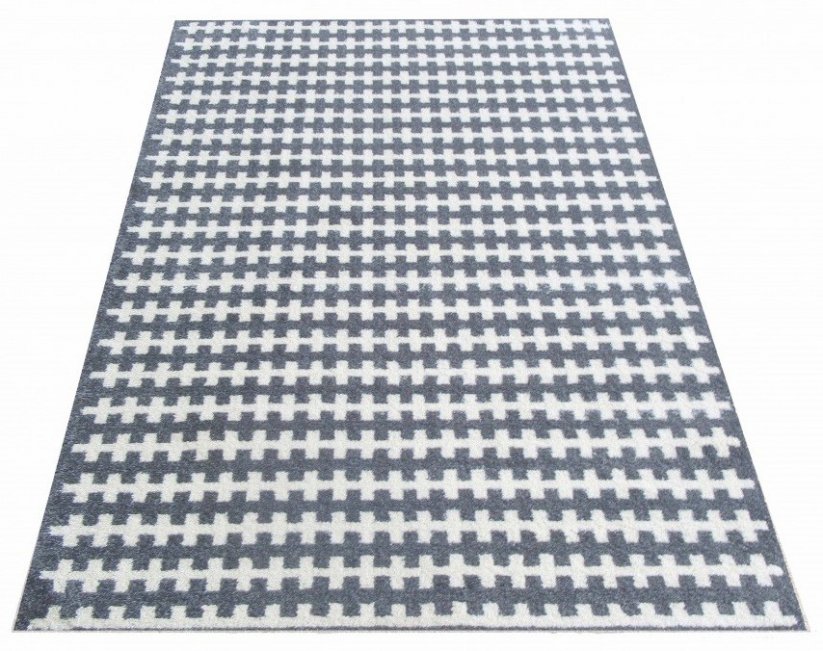 Štýlový koberec sivej farby do spálne