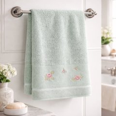 Bombažna brisača v zeleni barvi z velurnim robom in cvetlično vezenino