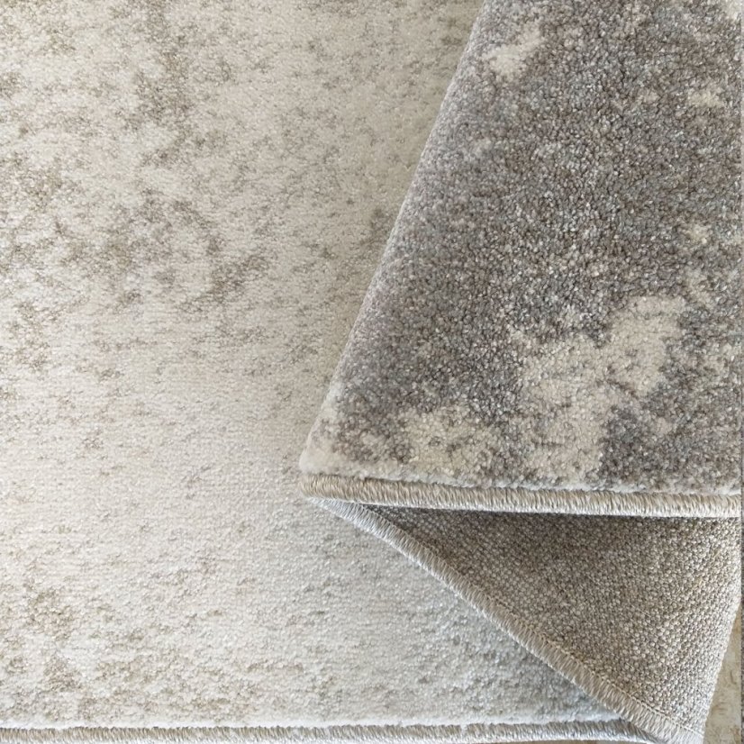 Beigefarbener Teppich mit modernem geometrischem Muster