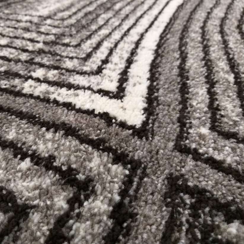 Moderni sivi tepih s apstraktnim motivom