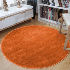 Jednobarevný kulatý koberec oranžové barvy