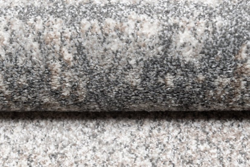Beige-grauer Designteppich mit abstraktem Muster 