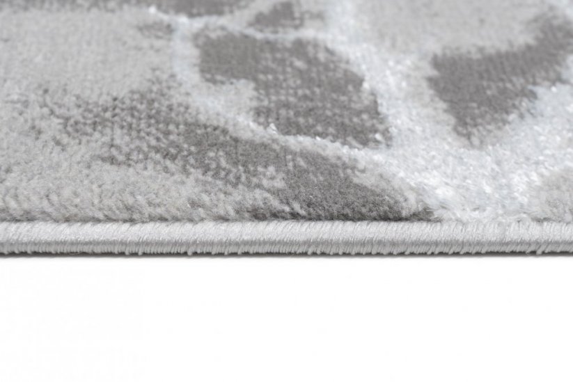 Schlichter moderner Teppich in Grau mit weißem Motiv
