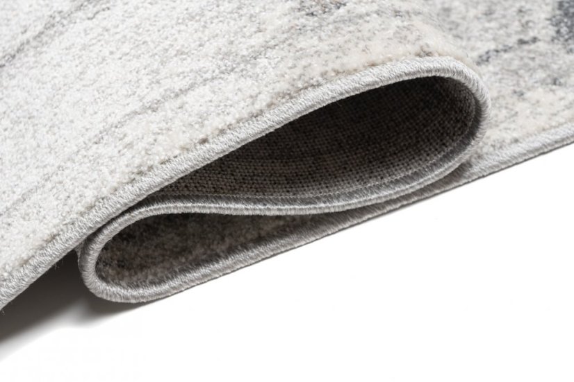 Beige-grauer Designteppich mit abstraktem Muster 